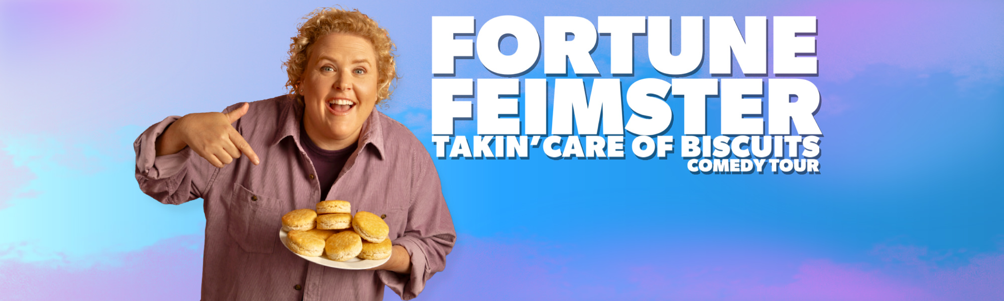 Comedian Fortune Feimster in front of a blue and pink cloud-like background. The background features the words Fortune Feimster Takin' Care of Biscuits Comedy Tour.